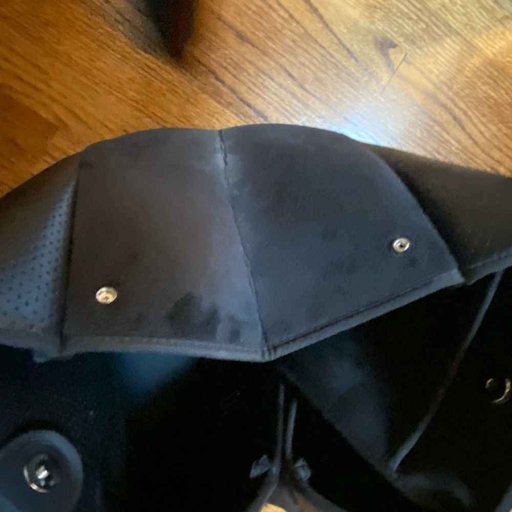 Black like leather soft with side closures and attached mini bag